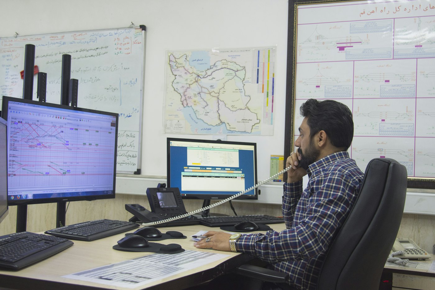 Man at a desk talking on the phone