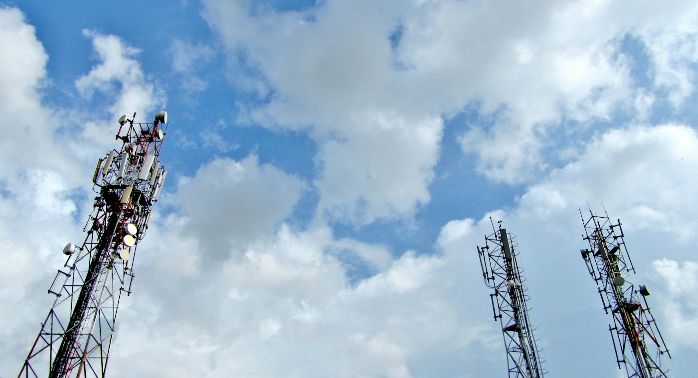 Telecom towers under a cloudy sky